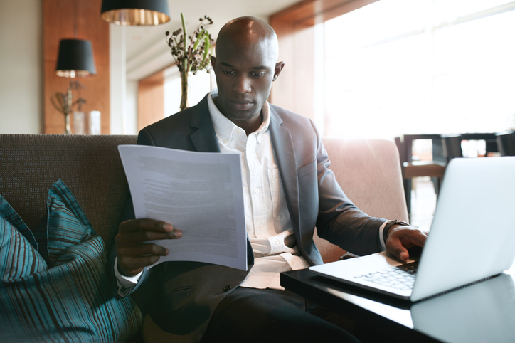 Business professional reviewing notes before a meeting.